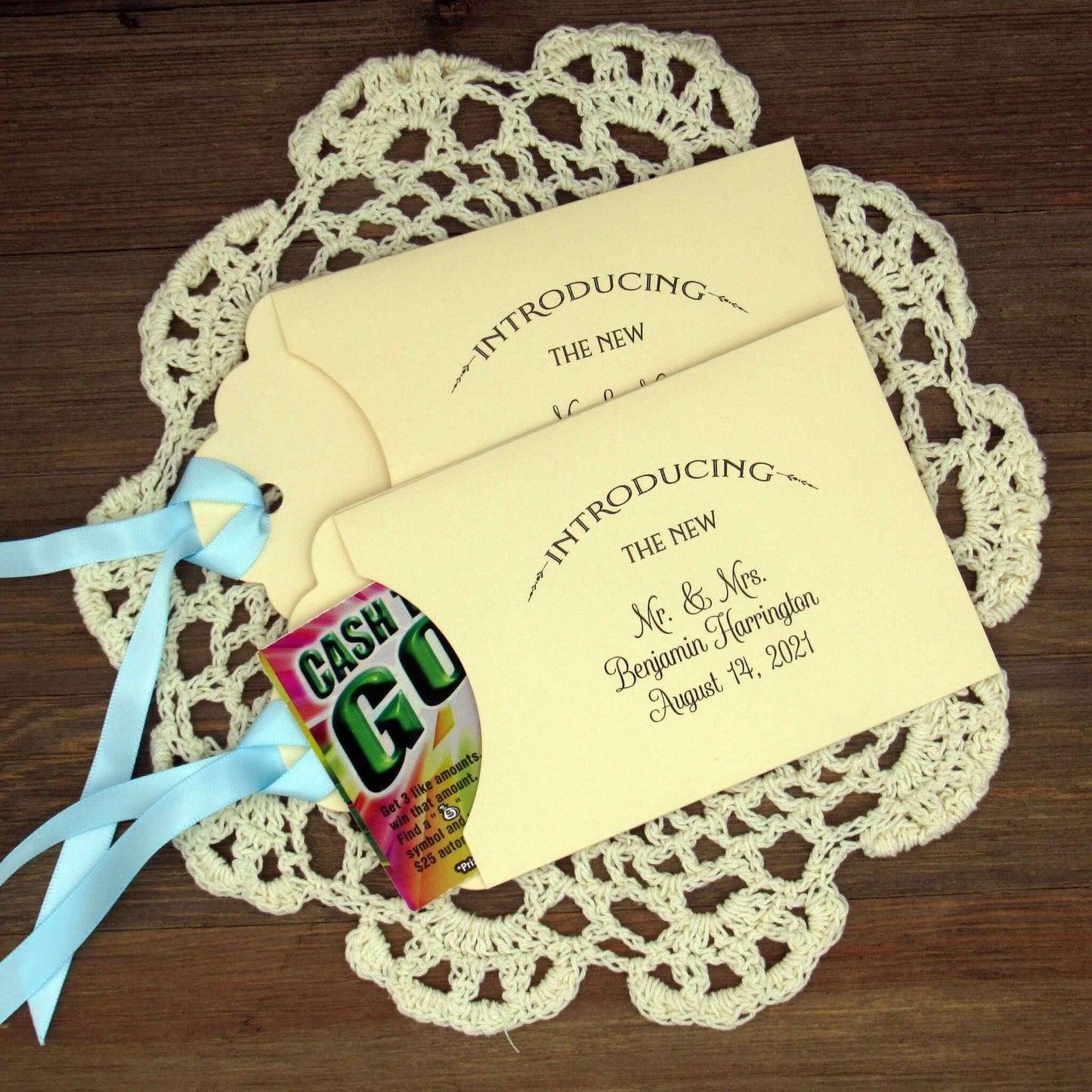Lottery Ticket Wedding Guest Favors personalized for the bride and groom.  Printed with 'introducing the new Mr. & Mrs. followed by your personal information.  Slide a lottery ticket in these for a fun favor.  Your choice of envelope and ribbon color.