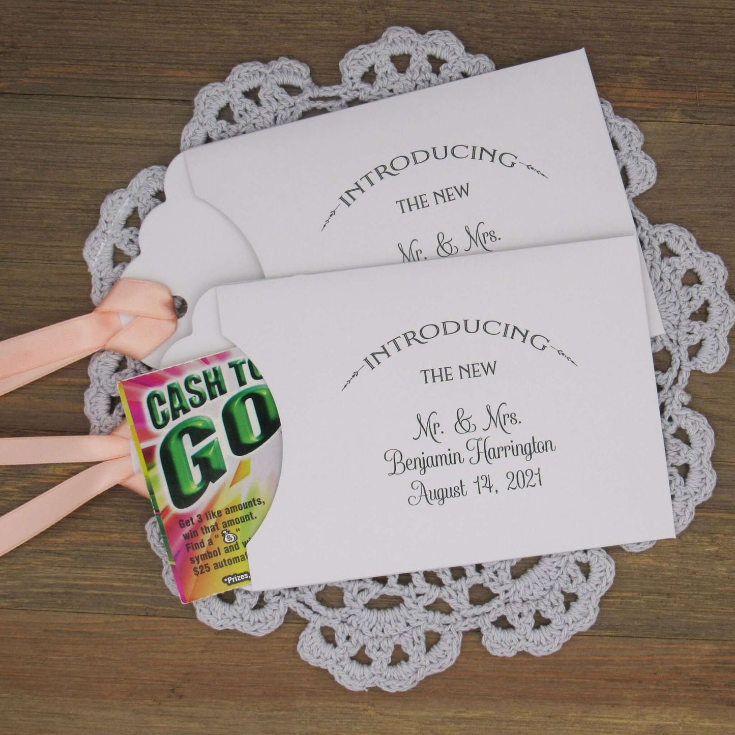 Lottery Ticket Wedding Guest Favors personalized for the bride and groom.  Printed with 'introducing the new Mr. & Mrs. followed by your personal information.  Slide a lottery ticket in these for a fun favor.  Your choice of envelope and ribbon color.