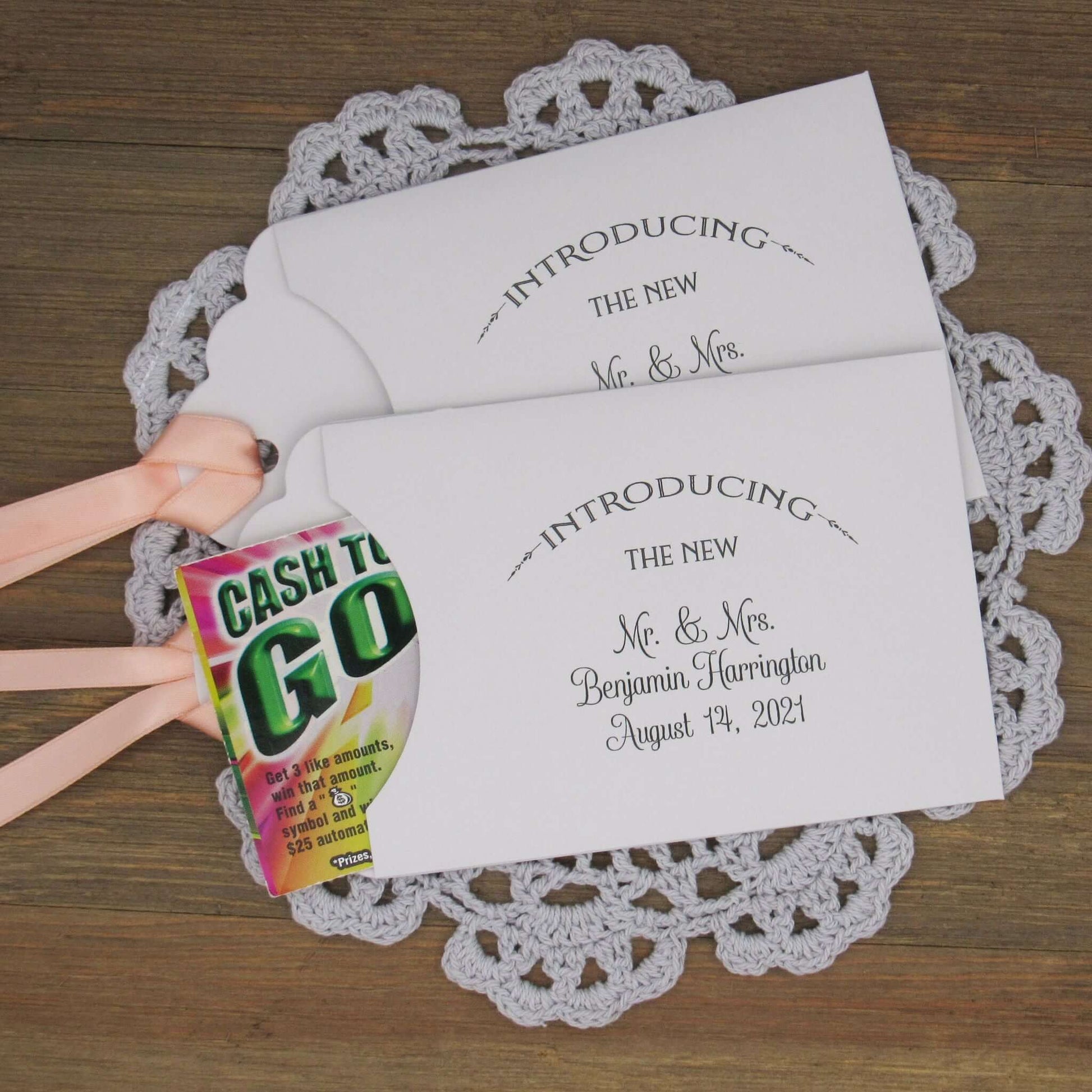 Lottery Ticket Wedding Guest Favors personalized for the bride and groom.  Printed with 'introducing the new Mr. & Mrs. followed by your personal information.  Slide a lottery ticket in these for a fun favor.  Your choice of envelope and ribbon color.