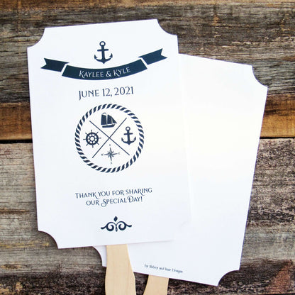 Personalized Nautical Theme Wedding Fans  printed on white card stock with navy text.  Hand fans are personalized for the bride and groom, fans ship assembled and ready to use.  Two sided with handle hidden between for a more finished look.  