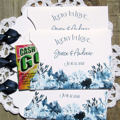 Navy Blue Wedding Guest Favors, slide a lotto ticket in to see who wins.  Envelopes are printed on white card stock adorned with blue flowers and a navy blue ribbon comes attached.  Lucky In Love printed with the bride and grooms names below.  