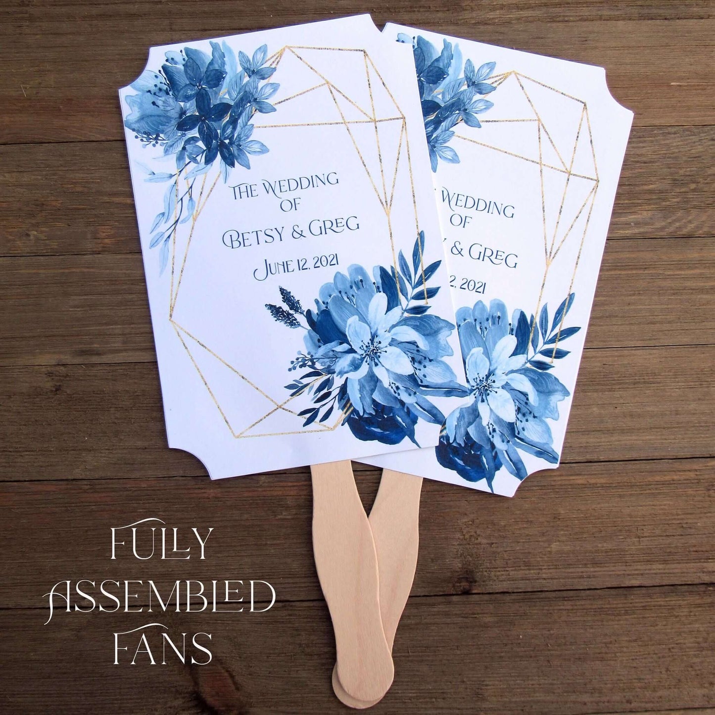 Blue Wedding Fans Assembled with a geometric design gives these fans a modern flare.  Printed on white card stock with blue flowers and personalized for the bride and groom.  Two sided with handle hidden between, printing on one side only.  Fans ship assembled and ready for your special day.