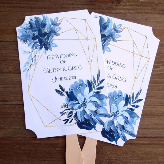 Blue Wedding Fans Assembled with a geometric design gives these fans a modern flare.  Printed on white card stock with blue flowers and personalized for the bride and groom.  Two sided with handle hidden between, printing on one side only.  Fans ship assembled and ready for your special day.