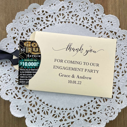 Personalized fun engagement party favors, envelopes for a lotto ticket  party favor.  Your choice of envelope color and ribbon color to match your party theme.  Celebrate your engagement in style with these unique engagement party favors.