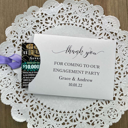 Personalized fun engagement party favors, envelopes for a lotto ticket  party favor.  Your choice of envelope color and ribbon color to match your party theme.  Celebrate your engagement in style with these unique engagement party favors.
