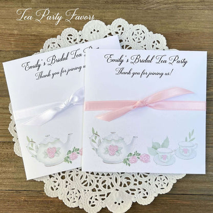 Tea Party Bridal Shower Favors personalized for the bride to be.  Slide tea bags in the envelope for the perfect tea party table favor.  Adorned with teapot and teacups your choice of pink or white ribbon.