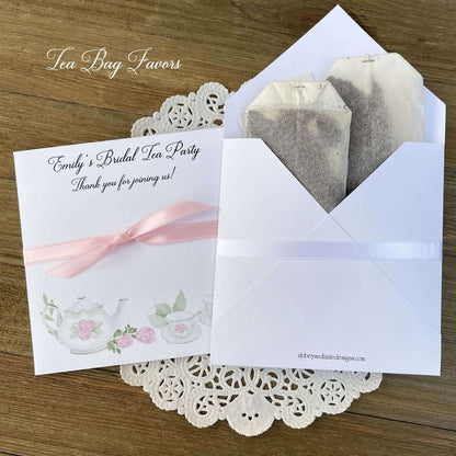 Tea Party Bridal Shower Favors personalized for the bride to be.  Slide tea bags in the envelope for the perfect tea party table favor.  Adorned with teapot and teacups your choice of pink or white ribbon