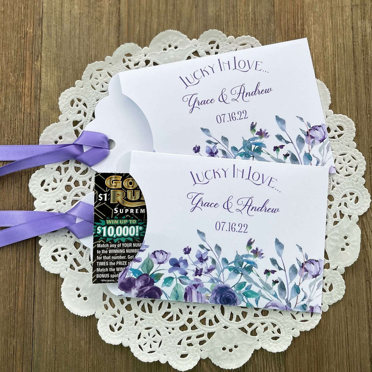 Personalized Lavender Wedding Favors,  lotto ticket favors.  White card stock envelopes adorned with lavender flowers.  Lavender ribbon comes attached.