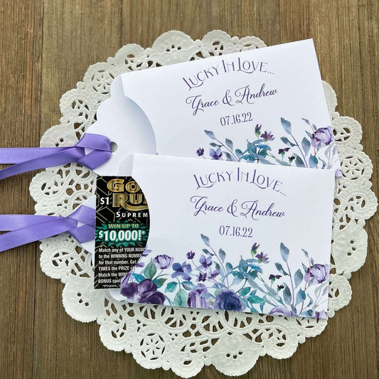 Personalized Lavender Wedding Favors,  lotto ticket favors.  White card stock envelopes adorned with lavender flowers.  Lavender ribbon comes attached.