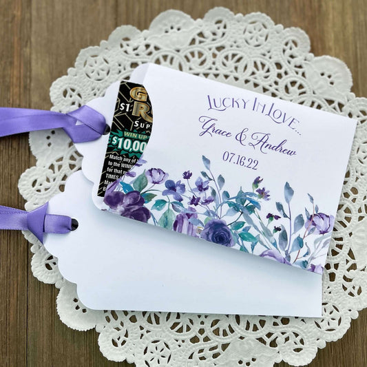 Personalized Lavender Wedding Favors,  lotto ticket favors.  White card stock envelopes adorned with lavender flowers.  Lavender ribbon comes attached.