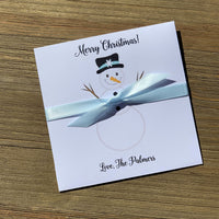 Small Holiday Gift, slide a lotto ticket in for a fun little gift or Holiday party favor.  White envelopes printed with a snowman, Merry Christmas and your name.  Each comes with a light blue ribbon attached.  