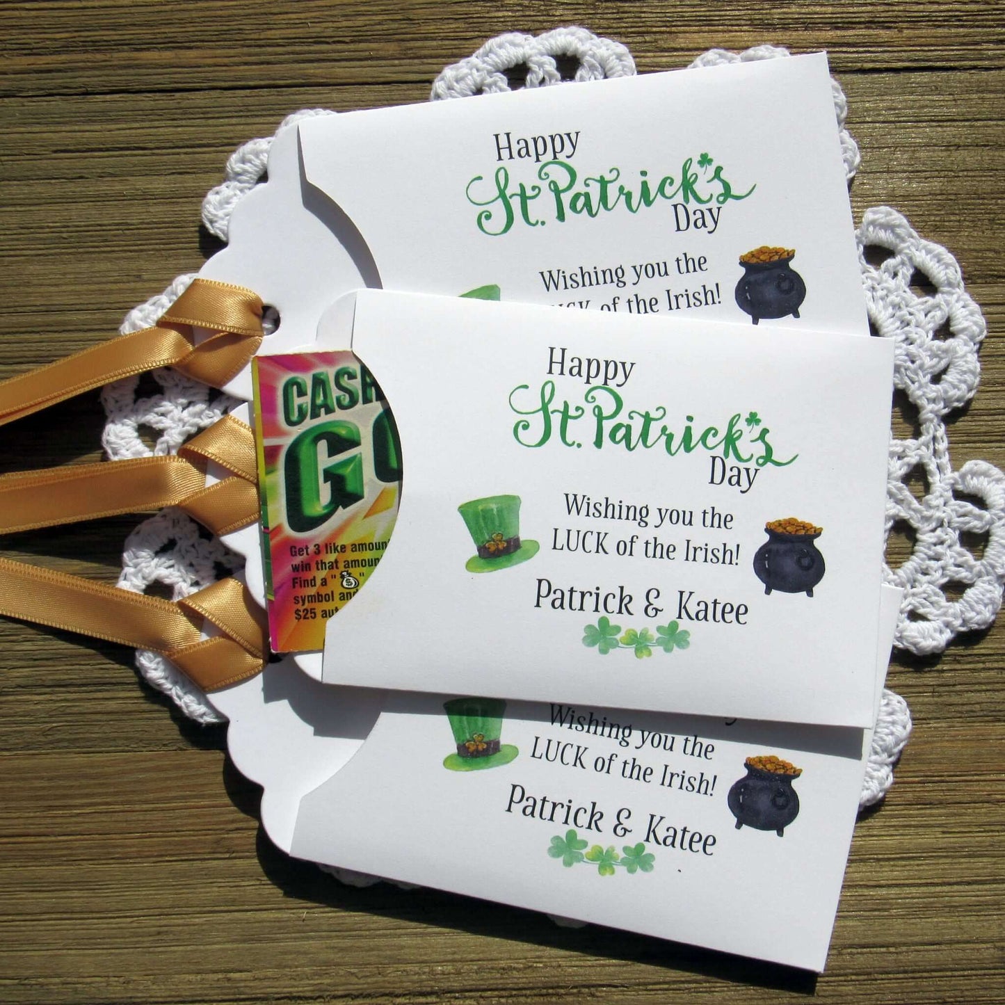 Personalized St Patrick's Day Party Favors, 'Happy St. Patrick's Day, wishing you the LUCK of the Irish'.  Printed on white card stock, adorned with a green hat, pot of gold and gold ribbon attached.  Slide a lottery ticket in the open end and see who has the LUCK of the Irish.