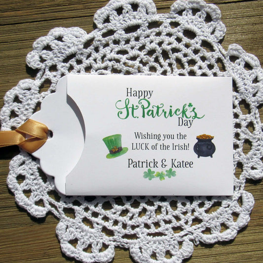 Personalized St Patrick's Day Party Favors, 'Happy St. Patrick's Day, wishing you the LUCK of the Irish'.  Printed on white card stock, adorned with a green hat, pot of gold and gold ribbon attached.  Slide a lottery ticket in the open end and see who has the LUCK of the Irish.