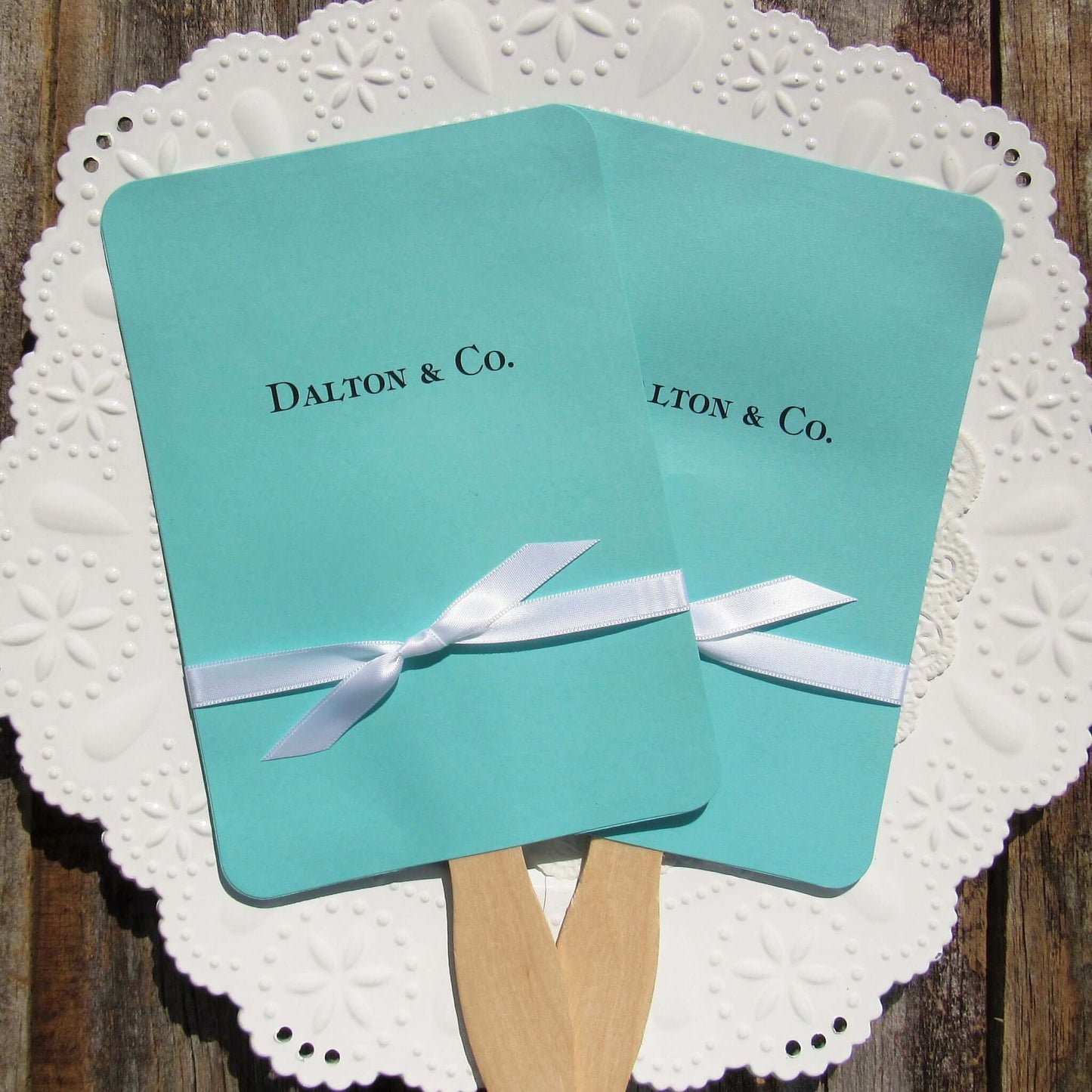 An elegant take on the hand fan , these Aqua Wedding Fans with Ribbon are sure to be appreciated on that hot sunny day.  Personalized with couples last name & Co.  White ribbon is included and comes attached.