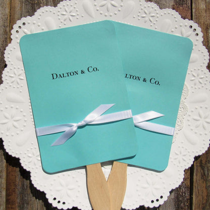 An elegant take on the hand fan , these Aqua Wedding Fans with Ribbon are sure to be appreciated on that hot sunny day.  Personalized with couples last name & Co.  White ribbon is included and comes attached.