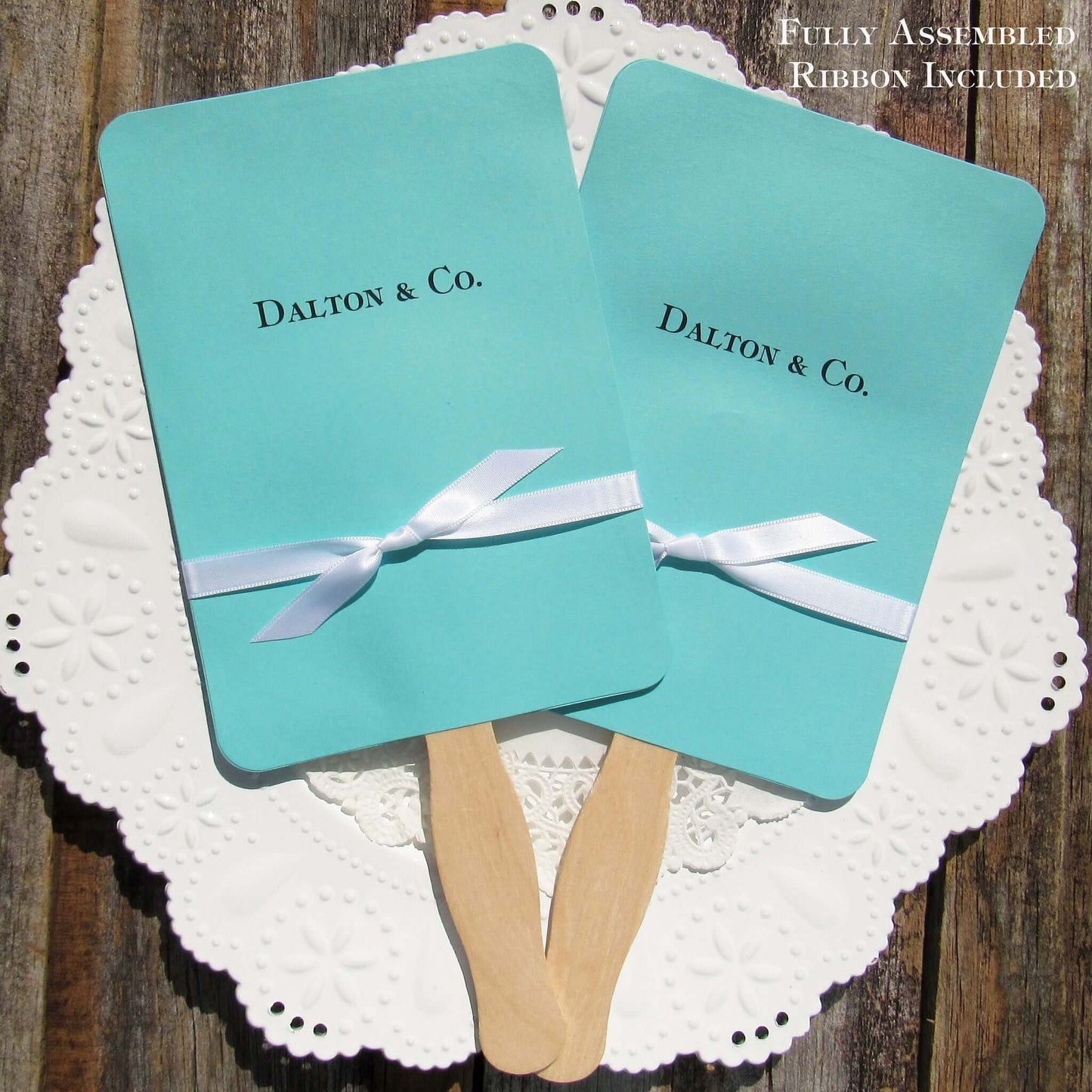 An elegant take on the hand fan , these Aqua Wedding Fans with Ribbon are sure to be appreciated on that hot sunny day.  Personalized with couples last name & Co.  White ribbon is included and comes attached.