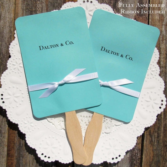 An elegant take on the hand fan , these Aqua Wedding Fans with Ribbon are sure to be appreciated on that hot sunny day.  Personalized with couples last name & Co.  White ribbon is included and comes attached.