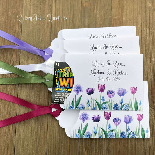 Tulip Wedding Reception Favors adorned with purple tulips these are so perfect for your spring wedding.  Envelopes are white with 'lucky in love' and the bride and grooms names and wedding date.  Ribbon included and comes attached.  Slide a lotto ticket in for a fun favor.
