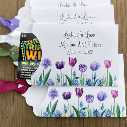 Tulip Wedding Reception Favors adorned with purple tulips these are so perfect for your spring wedding.  Envelopes are white with 'lucky in love' and the bride and grooms names and wedding date.  Ribbon included and comes attached.  Slide a lotto ticket in for a fun favor.