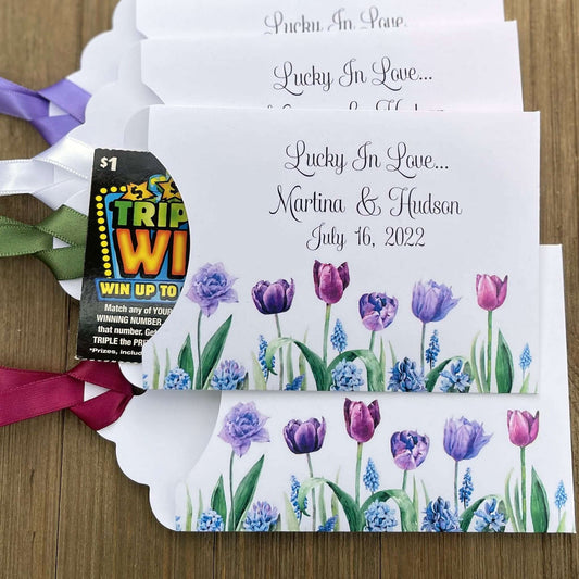 Tulip Wedding Reception Favors adorned with purple tulips these are so perfect for your spring wedding.  Envelopes are white with 'lucky in love' and the bride and grooms names and wedding date.  Ribbon included and comes attached.  Slide a lotto ticket in for a fun favor.