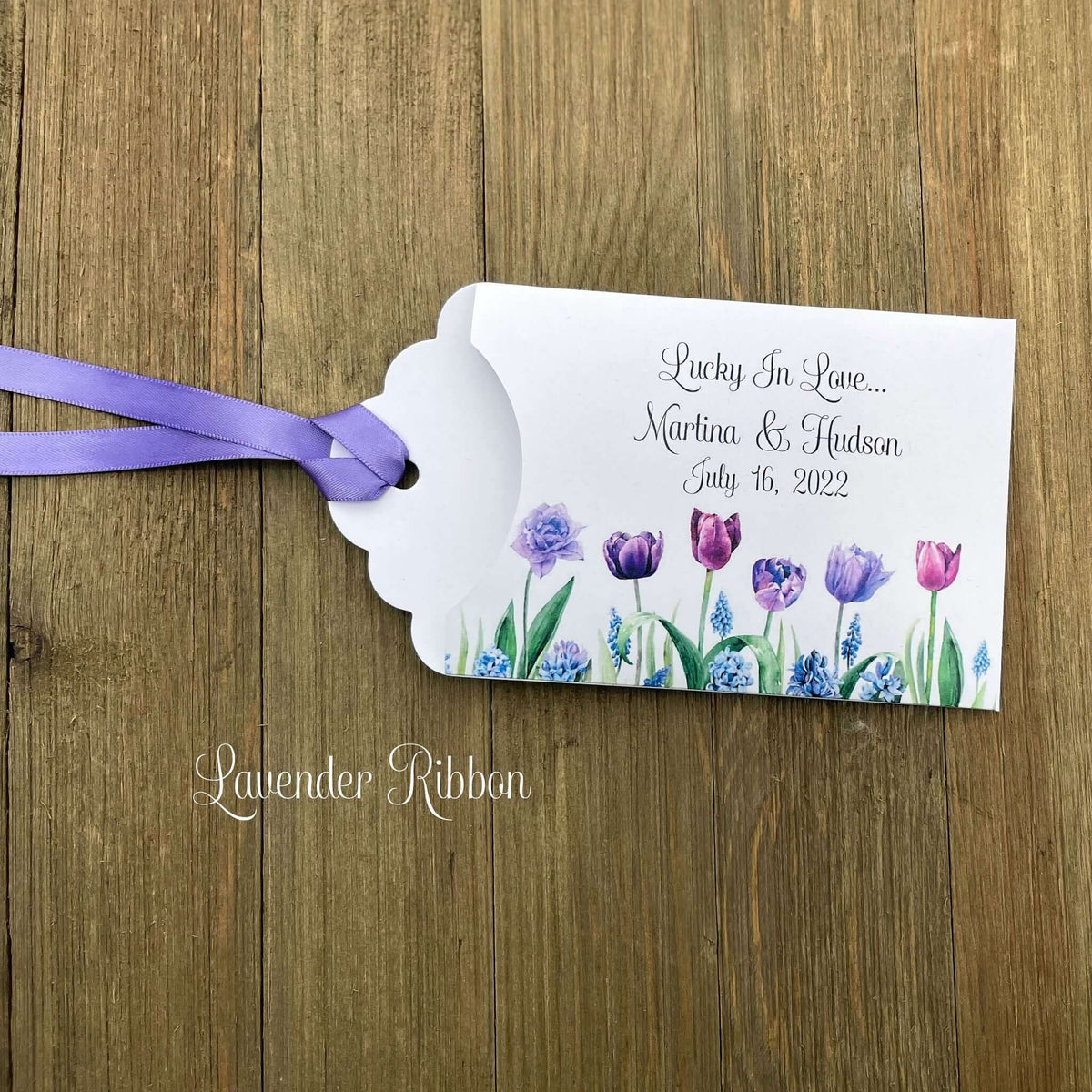 Tulip Wedding Reception Favors adorned with purple tulips these are so perfect for your spring wedding.  Envelopes are white with 'lucky in love' and the bride and grooms names and wedding date.  Ribbon included and comes attached.  Slide a lotto ticket in for a fun favor.