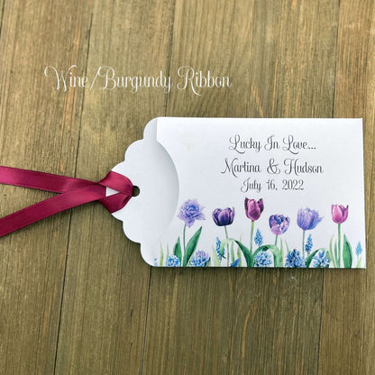 Tulip Wedding Reception Favors adorned with purple tulips these are so perfect for your spring wedding.  Envelopes are white with 'lucky in love' and the bride and grooms names and wedding date.  Ribbon included and comes attached.  Slide a lotto ticket in for a fun favor.