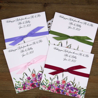 Purple Floral Wedding Guest Favors printed on white card stock with ribbon tied.  Personalized lottery ticket envelope favors, insert an instant lotto ticket for a fun guest favor.