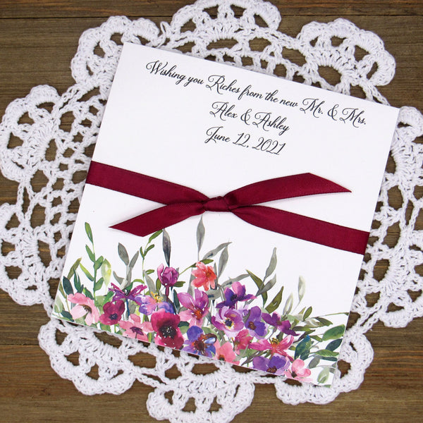 Purple floral Wedding Favors printed on white card stock with ribbon tied.  Personalized lottery ticket envelope favors, insert an instant lotto ticket for a fun guest favor.