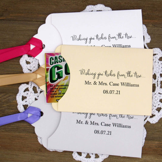 Personalized Lottery Ticket Wedding Favors, printed on card stock with ribbon attahced.  Each printed with 'Wishing you riches from the new Mr.  & Mrs.  Your choice of envelope and ribbon color.