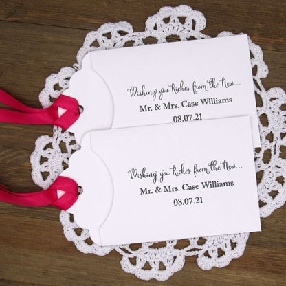 Personalized Lottery Ticket Wedding Favors, printed on card stock with ribbon attahced.  Each printed with 'Wishing you riches from the new Mr.  & Mrs.  Your choice of envelope and ribbon color.