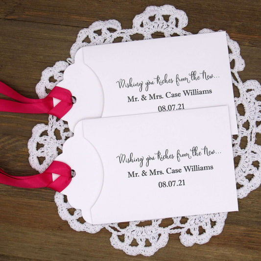 Personalized Lottery Ticket Wedding Favors, printed on card stock with ribbon attahced.  Each printed with 'Wishing you riches from the new Mr.  & Mrs.  Your choice of envelope and ribbon color.