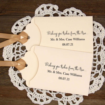 Personalized Lottery Ticket Wedding Favors, printed on card stock with ribbon attahced.  Each printed with 'Wishing you riches from the new Mr.  & Mrs.  Your choice of envelope and ribbon color.