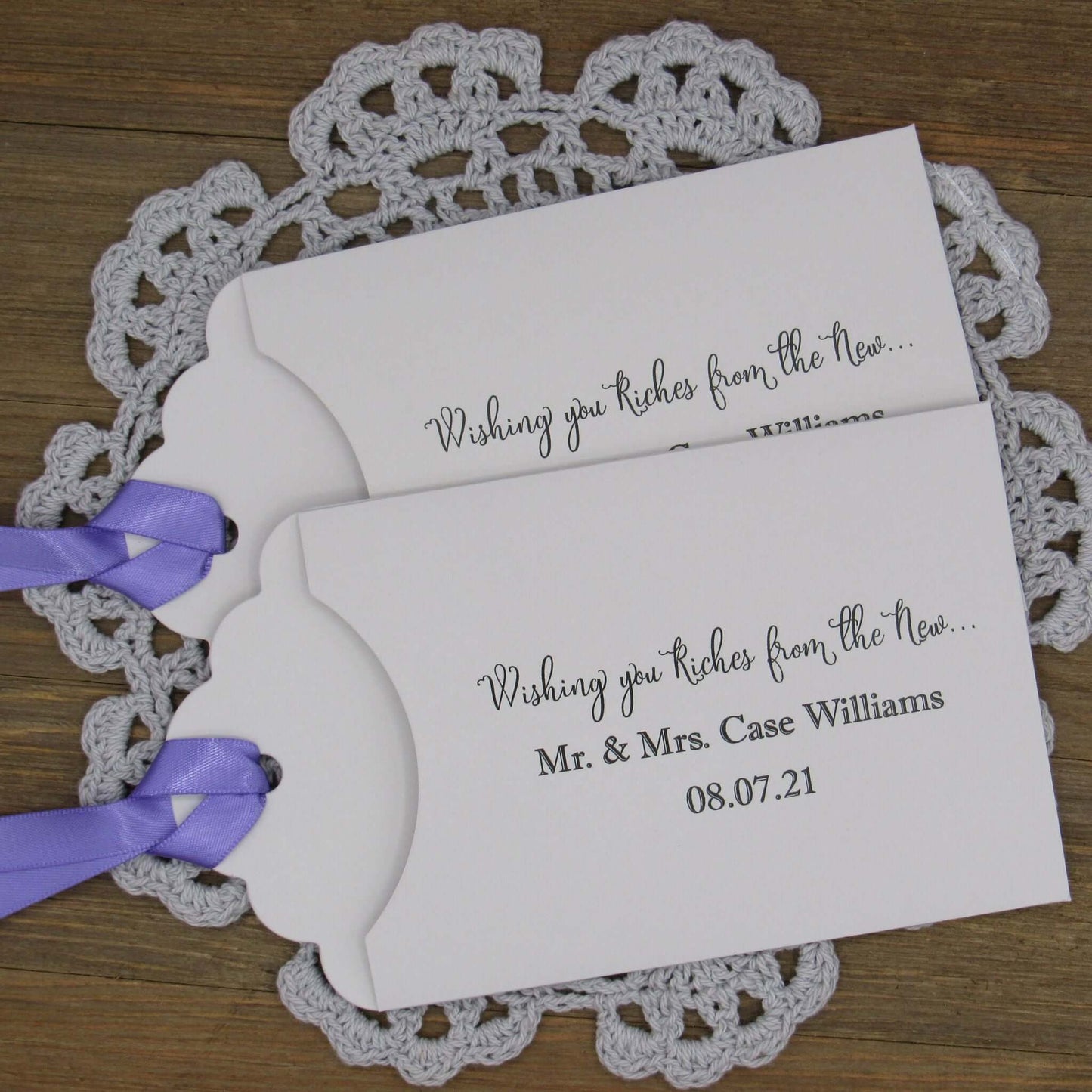 Personalized Lottery Ticket Wedding Favors, printed on card stock with ribbon attahced.  Each printed with 'Wishing you riches from the new Mr.  & Mrs.  Your choice of envelope and ribbon color.