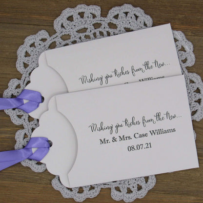 Personalized Lottery Ticket Wedding Favors, printed on card stock with ribbon attahced.  Each printed with 'Wishing you riches from the new Mr.  & Mrs.  Your choice of envelope and ribbon color.