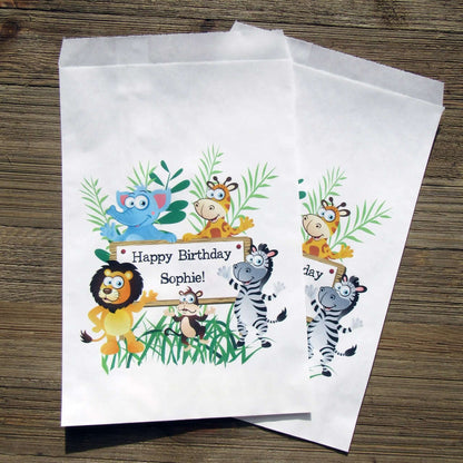 Zoo Birthday Party Favor Bags personalized for the guest of honor.  Printed on white bags adorned with cute zoo animals, these are perfect to fill with candy, popcorn, cookies or a goodie bag to take home.
