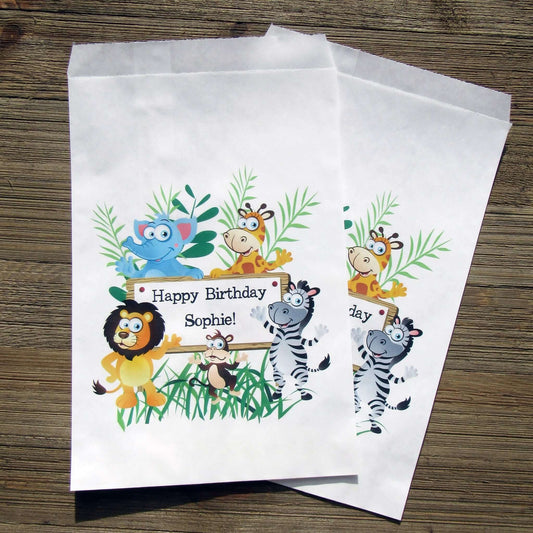 Zoo Birthday Party Favor Bags personalized for the guest of honor.  Printed on white bags adorned with cute zoo animals, these are perfect to fill with candy, popcorn, cookies or a goodie bag to take home.