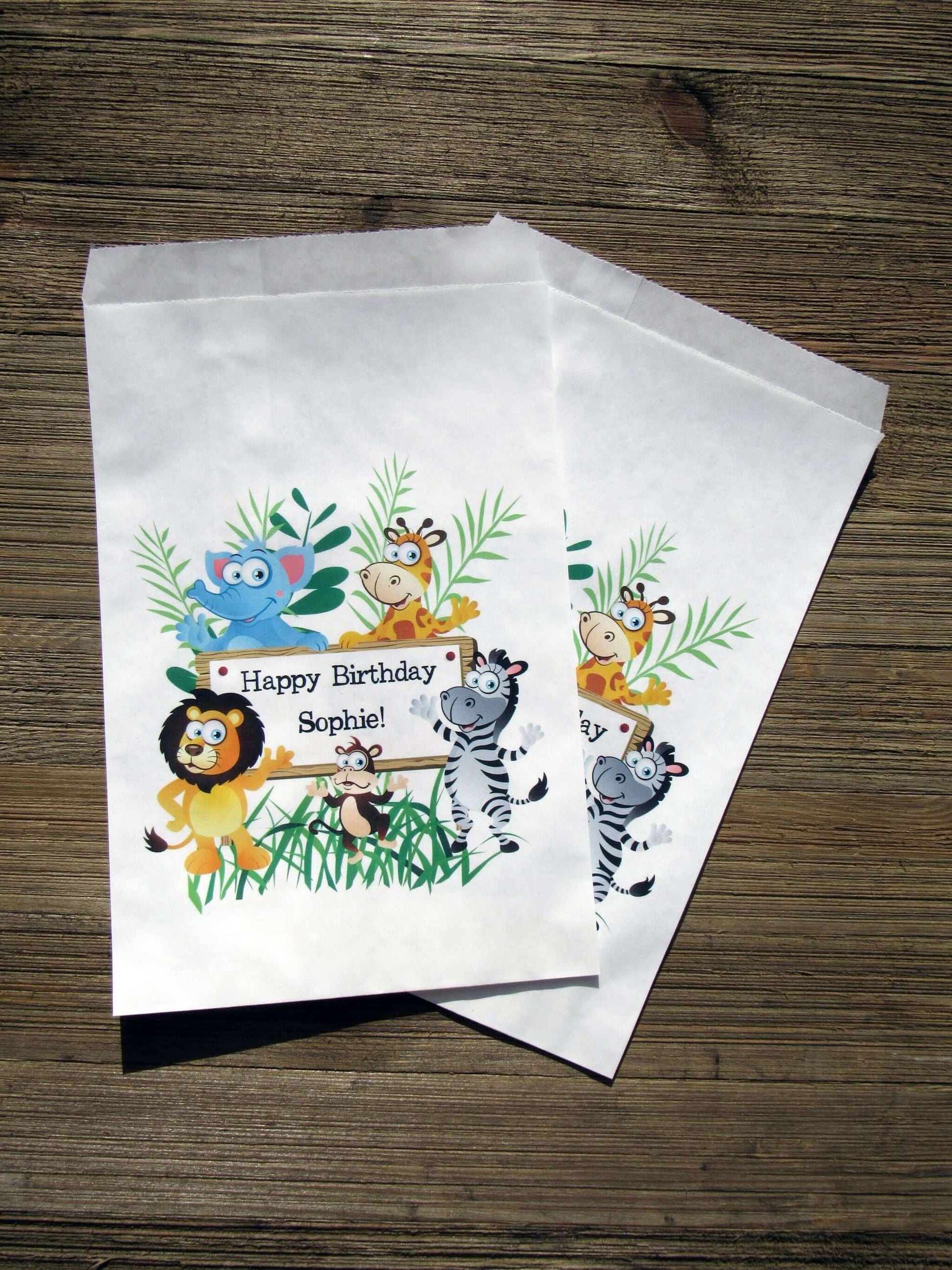 Zoo Birthday Party Favor Bags personalized for the guest of honor.  Printed on white bags adorned with cute zoo animals, these are perfect to fill with candy, popcorn, cookies or a goodie bag to take home.