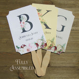 Monogram Wedding Fans, personalized for the bride and groom.  Large initial highlighted by pink and burgundy floral.  Fans ship fully assembled, 2 sided with hand hidden for a finished look.  Your choice of white, ivory or gray card stock.